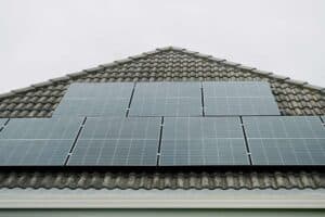 Solar panels installed on a pitched tiled roof of a home